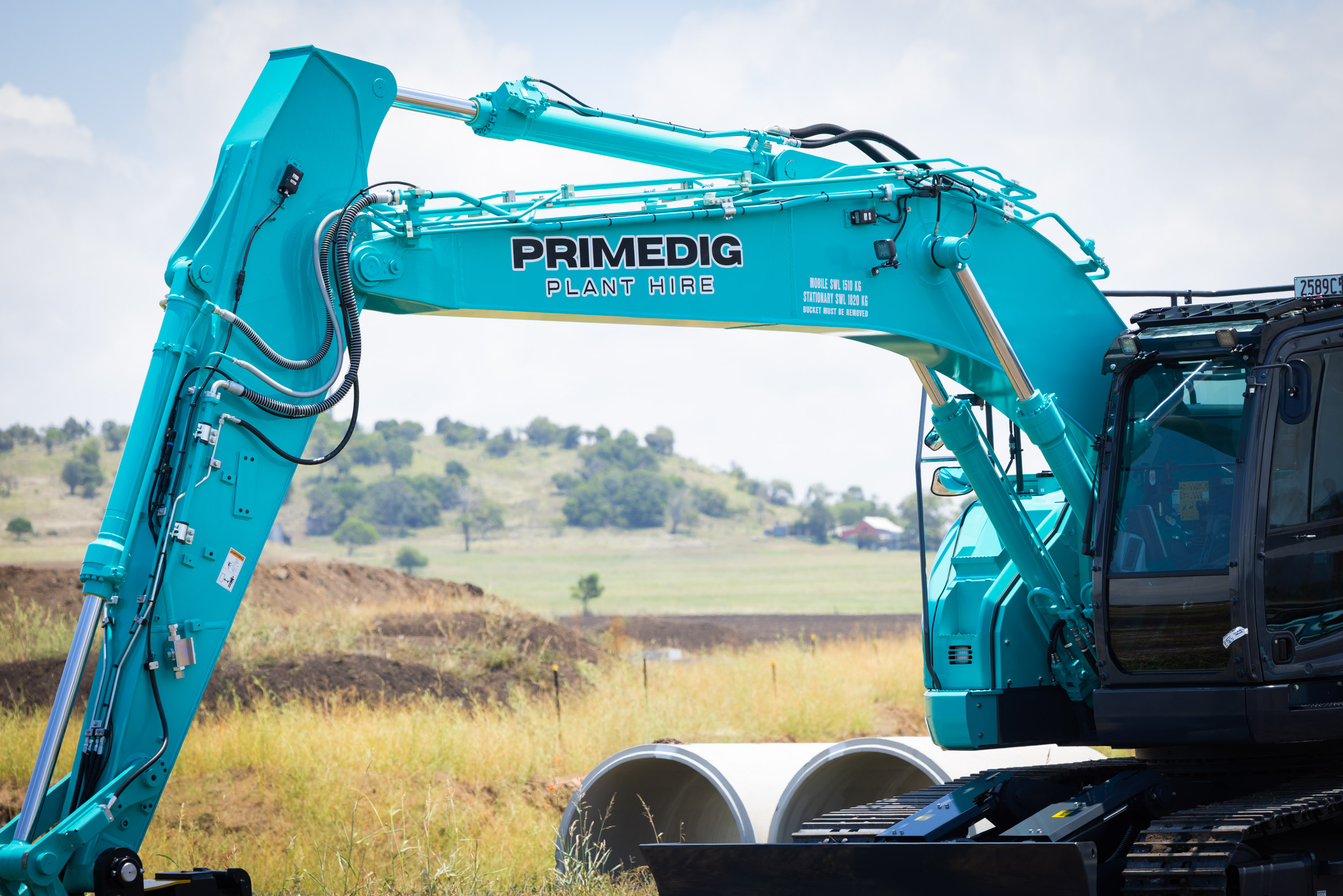 Kobelco SK225SR-7 excavator on a civil project with concrete pipes ready for install